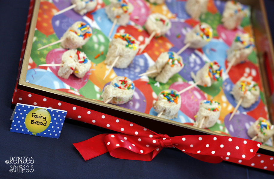 a tray with rolled-up Fairy Bread on toothpicks, pinwheel style